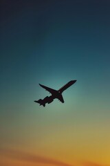 Shadowed silhouette of a sleek jet flying at dusk.