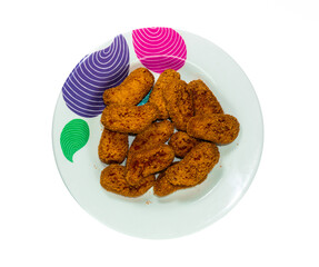 Some crispy nuggets neatly arranged on a plate in a solid white background