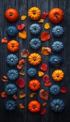 Fototapeta premium Autumnal Abundance A Vertical Array of Colorful Pumpkins and Scattered Leaves on Rustic Wood
