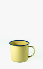 Obraz premium a yellow drinking cup used for drinking tea, coffee and others isolated on white background