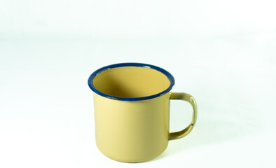 a yellow drinking cup used for drinking tea, coffee and others isolated on white background