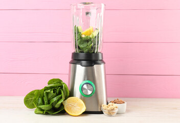 Modern blender with ingredients for smoothie on white wooden table