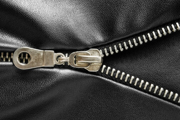 Unzipping black leather © Tarzhanova