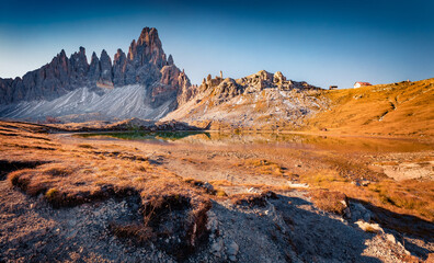 Obraz premium Paterno peak reflected in the Calm waters of Piani lake. Sunny autumn view of Dolomite alps. Gorgeous morning scene of Tre Cime Di Laveredo National Park, Italy, Europe. Travel the world..