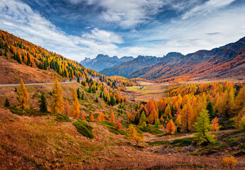 Spectacular autumn view of Valles valley. Unbelievable colors of Dolomite Alps with jagged peaks, rolling meadows, pastures and streams. Fantastic morning scene of Italian countryside.