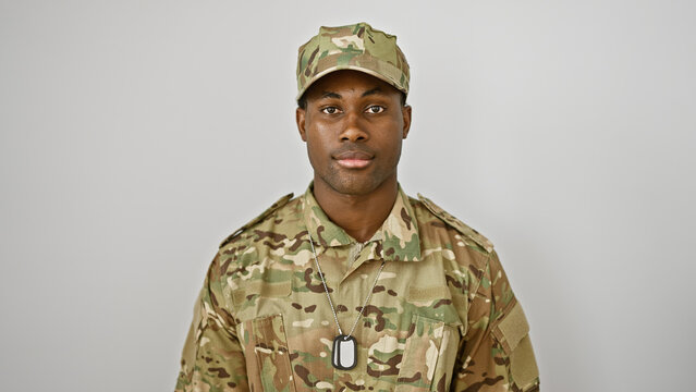 Portrait of a confident young adult black man wearing military camouflage against a white background