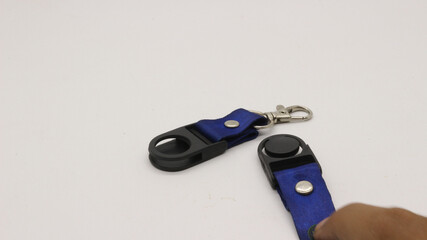 The neck lanyard is held by an adult's hand