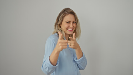 Caucasian blonde woman in blue shirt gesturing finger guns isolated on white background