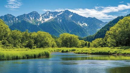 The fresh green landscapes of Kamikachi, with the tranquil Azusa River and the towering peaks of the Hotaka Mountains creating a serene and picturesque scene.