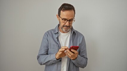 Middle-aged hispanic man using smartphone over isolated white background