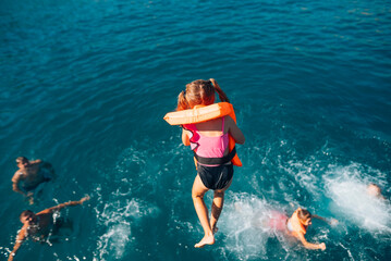 Joyful Summer Fun Kids Joyfully Playing in the Ocean with Brightly Colored Life Vests