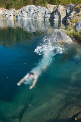 Obraz premium Diving man visible under transparent clear water of flooded old quarry in central Sweden near Romfartuna