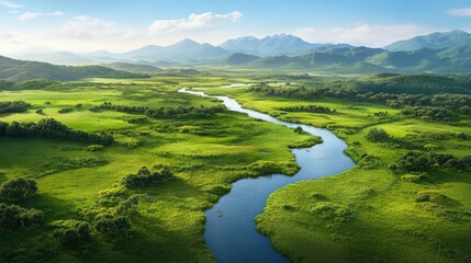 Obraz premium Breathtaking landscape featuring lush greenery, a winding river, and majestic mountains under a clear blue sky.