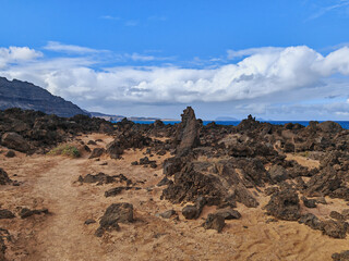 Clouds on the Atlantic Ocean and rugged terrain with volcanic rocks in Orzola, Lanzarote, Spain