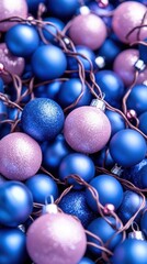 Colorful blue and pink Christmas ornaments, isolated on a white background.