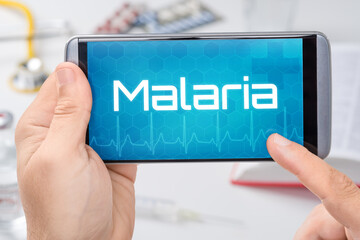 Smartphone mit dem Text Malaria auf dem Display
