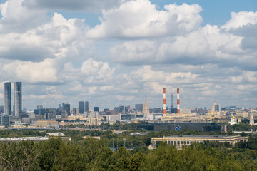 Visitors at Luzhniki Park enjoy stunning views of Moscow City is skyline, showcasing a mix of contemporary architecture and historical sites