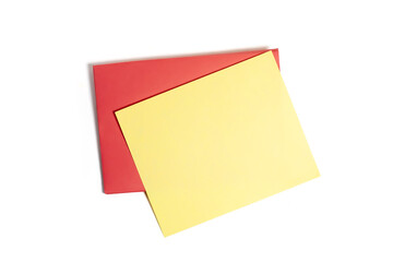 Blank yellow card on a vibrant red envelope for personal messages, invitations. Top view