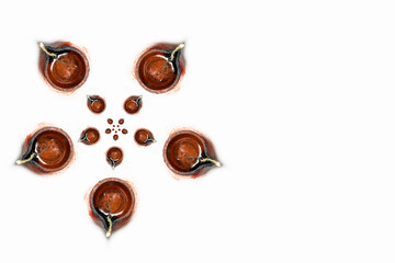 Happy Diwali - Top view of traditional clay oil lamps isolated on white background for Hindu festival celebrations.