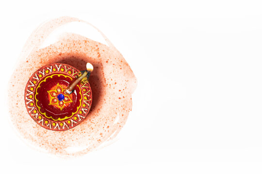 Happy Diwali - Close up of diwali diya lamp on white background with space for text. Hindu festival of lights.
