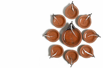 Hindu traditional clay diya arrangement for Diwali celebration on white background with copy space for text.