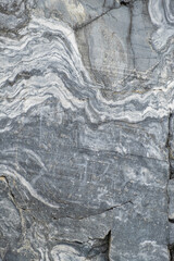 A detailed view of a marble surface exhibiting beautiful grey and white swirls, highlighting unique geological textures and patterns