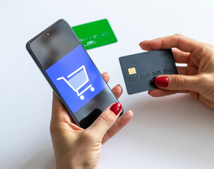 Shot of the woman holding credit card and the phone. Technology