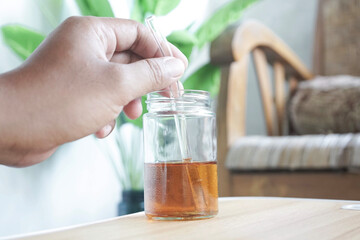 a man's hand is stirring tea