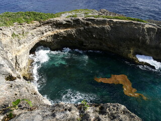waves crashing in the semi circular cavity in the cliff of Caye Plate in Marie Galante, caribbean...