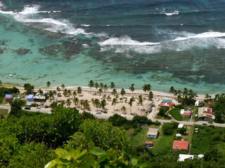 Aerial view of beach in la Désirade island in french west indies with coral reef stopping the...