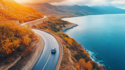 Aerial drone above top view of a car driving on an autumn mountain road near the sea, autumn forest landscape, nature scenery in a fall countryside. Vacation concept, travel by car. Generative AI.