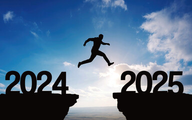 Happy new year 2025, Silhouette Man jumping from 2024 cliff to 2025 cliff on sky background. Сoncept of moving from year to year. New Year's concept.