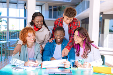 Happy diverse group of students studying in the library