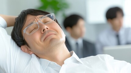 2409_012.an exhausted employee standing by their desk, stretching their arms overhead while grimacing from shoulder discomfort, with coworkers in the background focused on their tasks