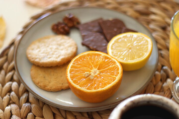 Pumpkins, various food and drinks, fall decorations, books and candles on the table. Fall hygge at home. Selective focus.
