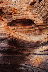The image is of a rocky cliff with a hole in the middle