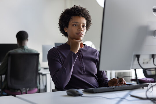 Young African American woman working on a computer in an office 