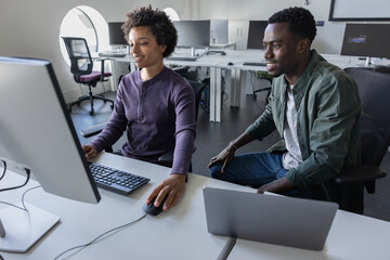 Students working together on a computer learning how to code