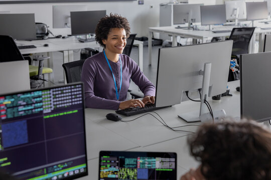 Happy student learning to code in a computer science laboratory