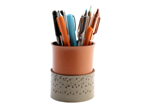 a cup with pens and pens in it