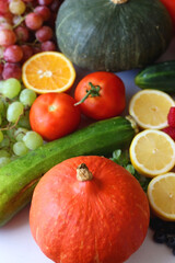 Various seasonal fruits and vegetables on white background. Summer and fall produce. Selective focus.