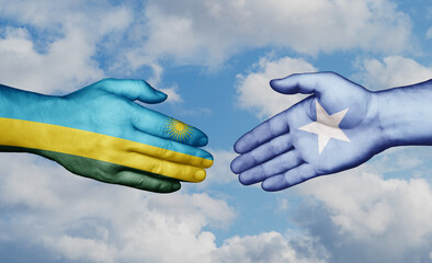 Somalia and Rwanda country handshaking with flags, consensus concept international co-operation...