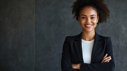 Cheerful businesswoman with crossed arms, radiating confidence in a professional portrait, highlighting her position as a web writer at an agency.