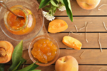 Homemade natural peach jam on wooden table and nature background