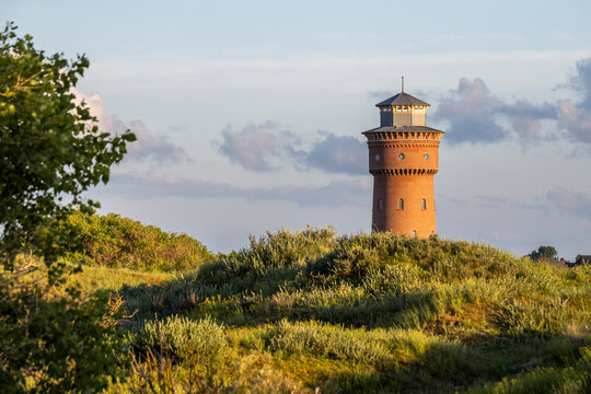 Historic water tower on the Island of Borkum in Lower Saxony, Germany surrounded by nature.