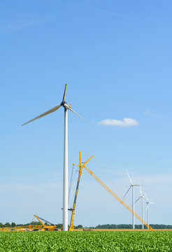Burnt wind turbine on a wind farm during the day.