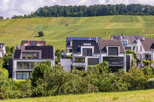 Modern single family homes with photovoltaic systems near Waiblingen in Baden-Wuerttemberg, Germany, surrounded by vineyards.
