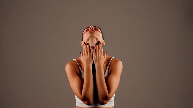 Young woman with perfect glowing skin and natural makeup posing for the camera with medical collagen patches under her eyes to reduce fatigue and puffiness. Skin care.Modern beauty tools concept 4k