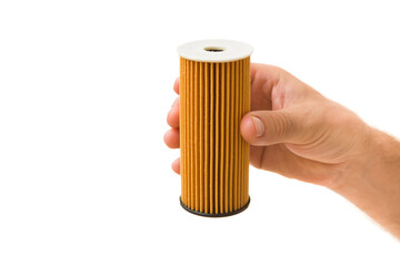 Young adult man hand holding and showing car new oil filter isolated on white background. Closeup. Front view.