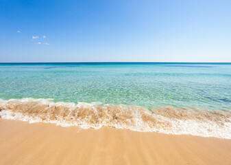 Crystal clear water gently lapping on tropical beach shore, Gallipoli, Italy.